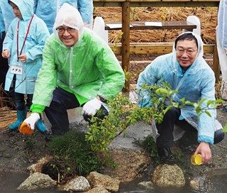 メダカとホタルを放流する当社社長の荒島（左）と村上あま市市長（右）